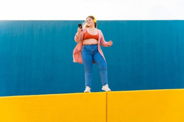 Beautiful and cheerful plus size young woman outdoors - Pretty overweight curvy female, concepts about femininity, women power, female emancipation, body positivity and body acceptance