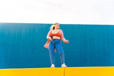 Beautiful and cheerful plus size young woman outdoors - Pretty overweight curvy female, concepts about femininity, women power, female emancipation, body positivity and body acceptance