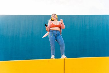 Beautiful and cheerful plus size young woman outdoors - Pretty overweight curvy female, concepts about femininity, women power, female emancipation, body positivity and body acceptance