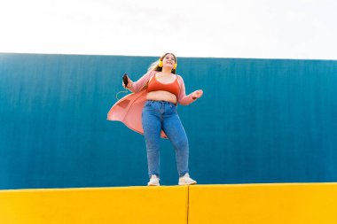 Beautiful and cheerful plus size young woman outdoors - Pretty overweight curvy female, concepts about femininity, women power, female emancipation, body positivity and body acceptance