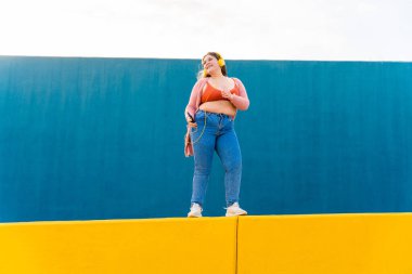 Beautiful and cheerful plus size young woman outdoors - Pretty overweight curvy female, concepts about femininity, women power, female emancipation, body positivity and body acceptance