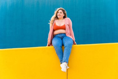 Beautiful and cheerful plus size young woman outdoors - Pretty overweight curvy female, concepts about femininity, women power, female emancipation, body positivity and body acceptance