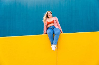 Beautiful and cheerful plus size young woman outdoors - Pretty overweight curvy female, concepts about femininity, women power, female emancipation, body positivity and body acceptance