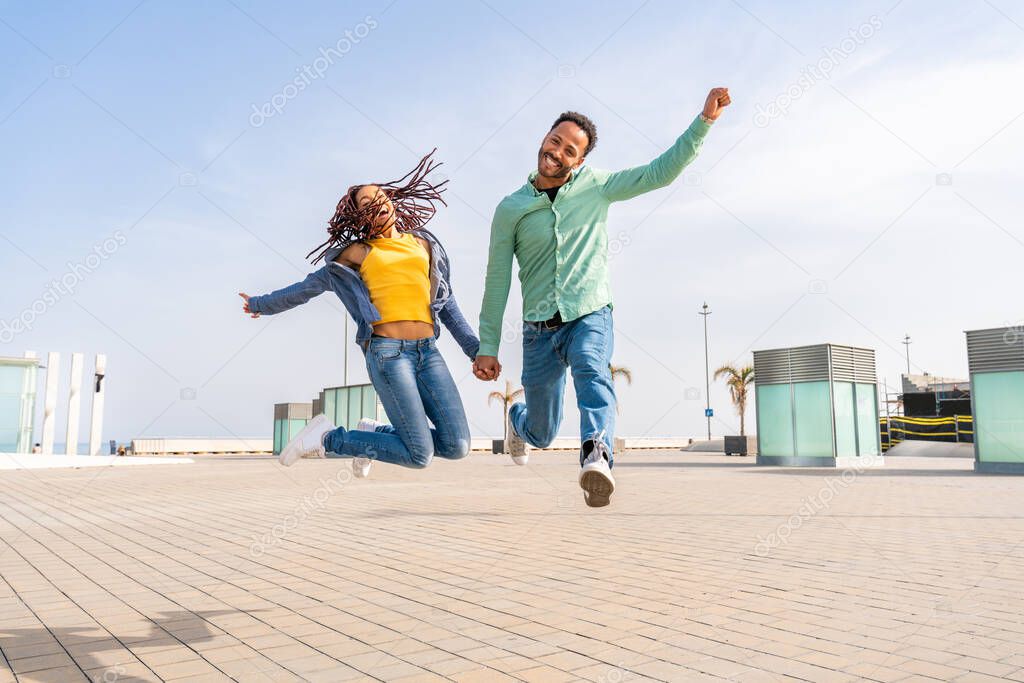 Beautiful happy hispanic latino couple of lovers dating outdoors - Tourists in Barcelona having fun during summer vacation