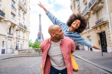 Paris şehir merkezini ve Eyfel Kulesi 'ni ziyaret eden siyah mutlu çift - Afrika kökenli Amerikalı turistler Avrupa' da seyahat ediyor ve açık havada flört ediyorlar