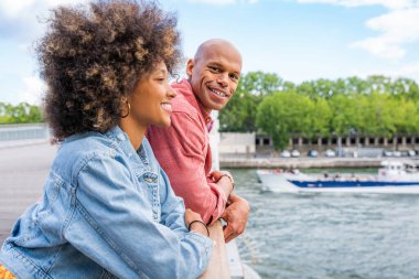 Paris şehir merkezini ve Eyfel Kulesi 'ni ziyaret eden siyah mutlu çift - Afrika kökenli Amerikalı turistler Avrupa' da seyahat ediyor ve açık havada flört ediyorlar