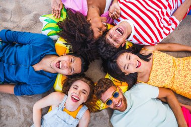 Multiethnic group of young happy friends bonding outside, having fun on summertime vacation - Multicultural cheerful people with summer clothes enjoying summer holidays, concepts about youth, friendship and positive emotion