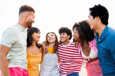 Multiethnic group of young happy friends bonding outside, having fun on summertime vacation - Multicultural cheerful people with summer clothes enjoying summer holidays, concepts about youth, friendship and positive emotion