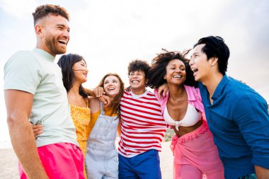 Multiethnic group of young happy friends bonding outside, having fun on summertime vacation - Multicultural cheerful people with summer clothes enjoying summer holidays, concepts about youth, friendship and positive emotion