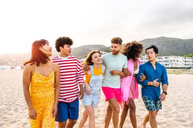 Multiethnic group of young happy friends bonding outside, having fun on summertime vacation - Multicultural cheerful people with summer clothes enjoying summer holidays, concepts about youth, friendship and positive emotion