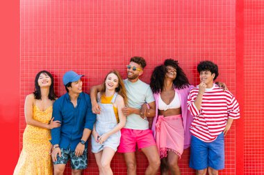Multiethnic group of young happy friends bonding outside, having fun on summertime vacation - Multicultural cheerful people with summer clothes enjoying summer holidays, concepts about youth, friendship and positive emotion