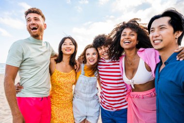 Multiethnic group of young happy friends bonding outside, having fun on summertime vacation - Multicultural cheerful people with summer clothes enjoying summer holidays, concepts about youth, friendship and positive emotion
