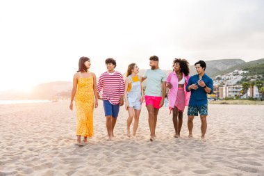 Multiethnic group of young happy friends bonding outside, having fun on summertime vacation - Multicultural cheerful people with summer clothes enjoying summer holidays, concepts about youth, friendship and positive emotion