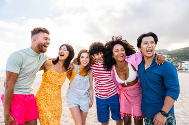 Multiethnic group of young happy friends bonding outside, having fun on summertime vacation - Multicultural cheerful people with summer clothes enjoying summer holidays, concepts about youth, friendship and positive emotion