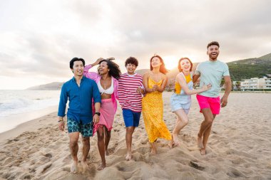 Multiethnic group of young happy friends bonding outside, having fun on summertime vacation - Multicultural cheerful people with summer clothes enjoying summer holidays, concepts about youth, friendship and positive emotion