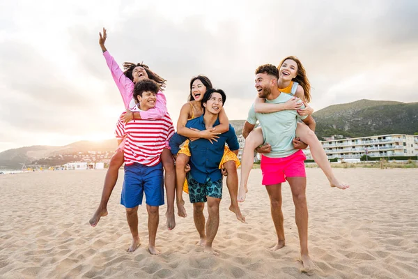 Multiethnic group of young happy friends bonding outside, having fun on summertime vacation - Multicultural cheerful people with summer clothes enjoying summer holidays, concepts about youth, friendship and positive emotion