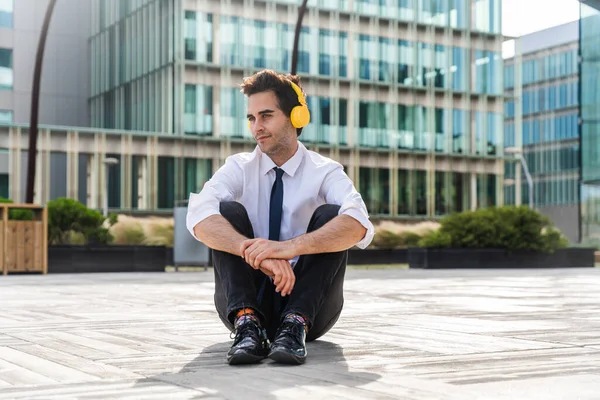 Happy Handsome Adult Businessman Wearing Elegant Suit Sitting Ground Listening — Stockfoto