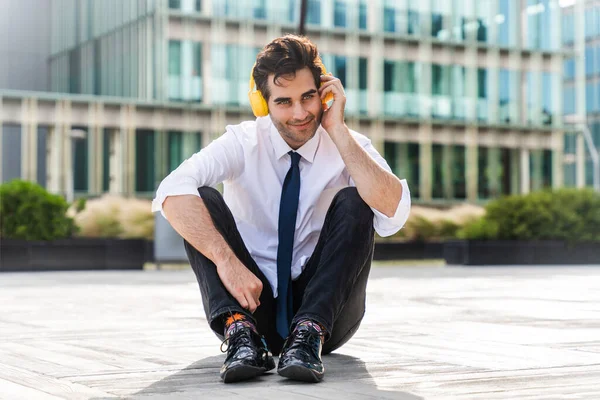 Happy Handsome Adult Businessman Wearing Elegant Suit Sitting Ground Listening — Foto Stock