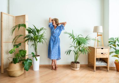 Beautiful mature senior woman at home, domestic life and leisure moments - 50-60 years old pretty female adult, concept about healthy lifestyle, apartment relocation, quality of life