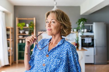 Beautiful mature senior woman at home, domestic life and leisure moments - 50-60 years old pretty female adult portrait, concept about healthy lifestyle, beauty and anti-aging