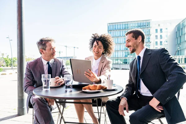Senior businessman, caucasian man and beautiful hispanic businesswoman meeting in a bar restaurant  - Three colleagues bonding in a cafe after work