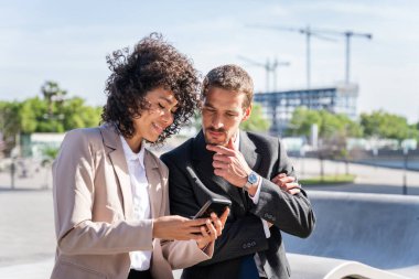 Multiracial group of business people bonding outdoors - International business corporate team wearing elegant suit meeting in a business park
