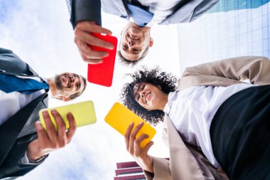 Multiracial group of business people bonding outdoors - International business corporate team wearing elegant suit meeting in a business park