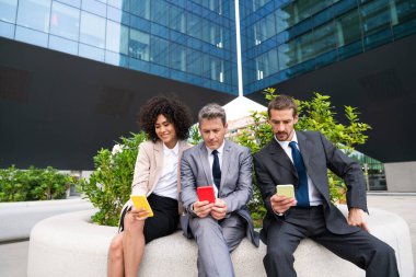 Multiracial group of business people bonding outdoors - International business corporate team wearing elegant suit meeting in a business park