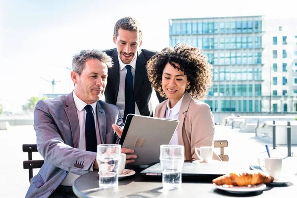 Senior businessman, caucasian man and beautiful hispanic businesswoman meeting in a bar restaurant  - Three colleagues bonding in a cafe after work
