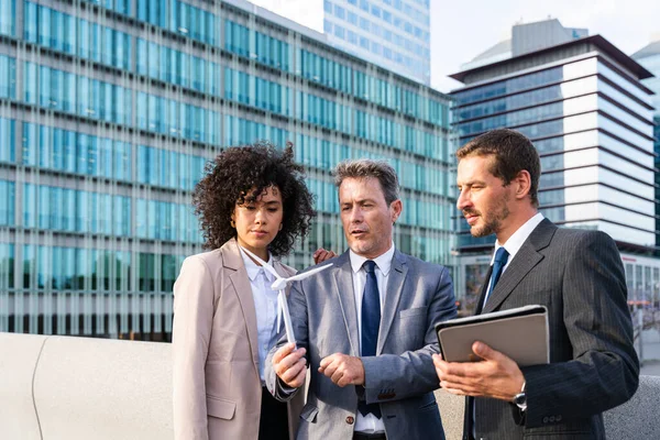 Multiracial group of business people bonding outdoors - International business corporate team wearing elegant suit meeting in a business park
