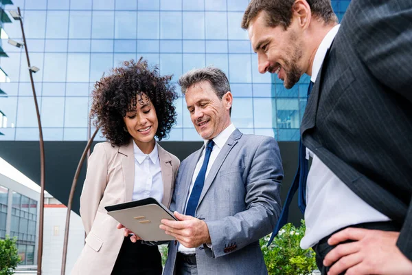 Multiracial group of business people bonding outdoors - International business corporate team wearing elegant suit meeting in a business park