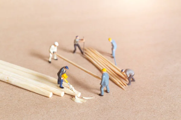 Miniature people carpenter making bamboo toothpick from bamboo, Recycle concept