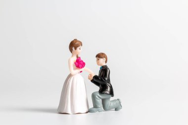 Miniature people Bride and groom wedding on grey  background ,Happy Valentines Day concept