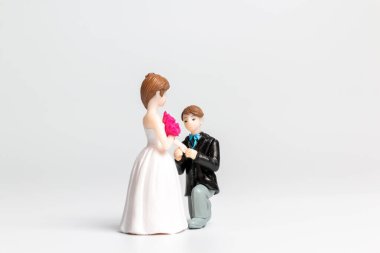 Miniature people Bride and groom wedding on grey  background ,Happy Valentines Day concept