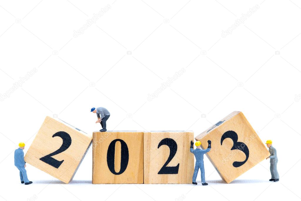 Miniature People Worker Team Create Number 2023 On Wooden Block , Happy New Year Concept