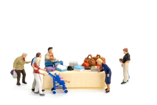 Miniature people Shoppers with discount tray for shopping discounted items on white background