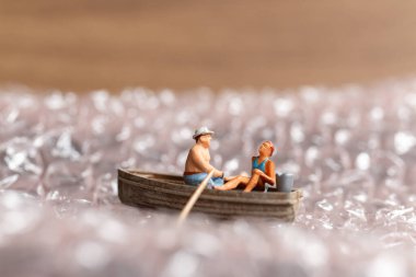 Miniature people ,Couple with boat sailing on pink bubble