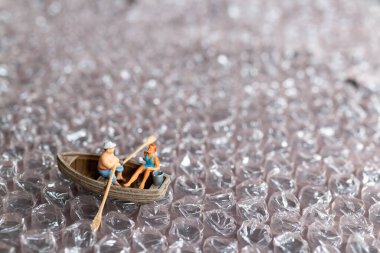 Miniature people ,Couple with boat sailing on pink bubble