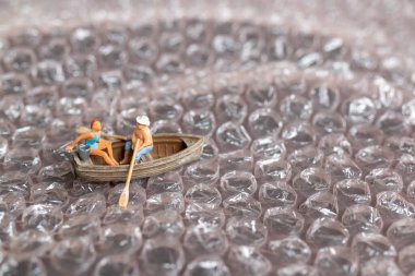 Miniature people ,Couple with boat sailing on pink bubble