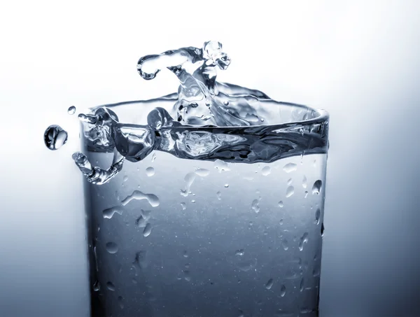 Vidrio lleno de agua aislado sobre fondo blanco — Foto de Stock