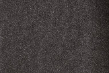 Dark gray background from natural slate. Texture of stone closeup. Graphite background macro.