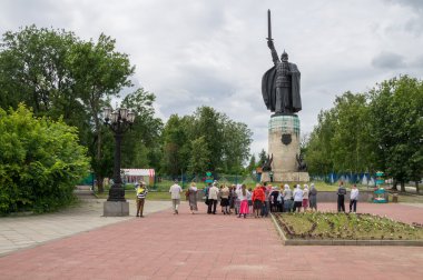 Russia. Murom. Ilya Muromets monument surrounded by tourists clipart