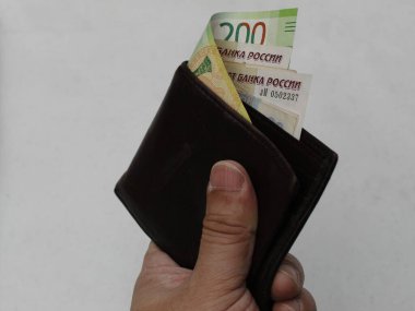 Rus parasıyla cüzdan tutan bir adamın eli.