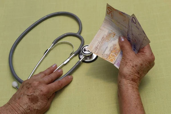 Hands Older Woman Holding Swedish Banknotes Stethoscope — 스톡 사진