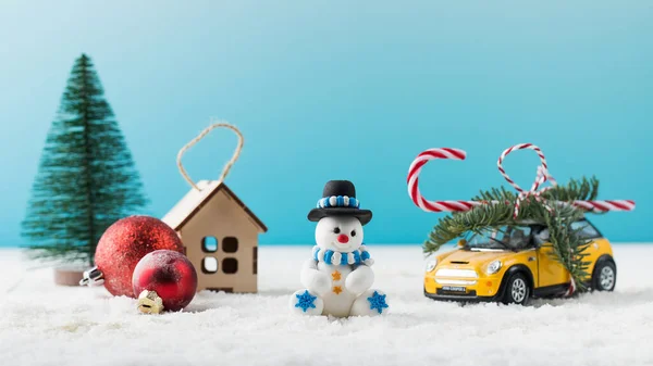 Lustige Weihnachtsmann-Figur Spielzeugauto mit Geschenk und Weihnachtsdekor auf Kunstschnee — Stockfoto