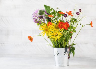 Metal kovadaki güzel yaz çiçekleri. Yaz dönemi. Boşluğu kopyala.