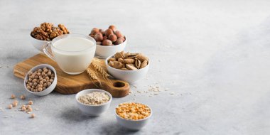 Arka planda fındıklı, yulaf ezmeli ve baklagilli bir fincanda sebze sütü. Boşluğu kopyala.