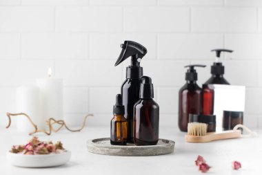 Açık arkaplanda çevre dostu organik güzellik ürünleri olan farklı kahverengi cam şişeler. Doğal DIY kozmetik ürünleri kavramı.