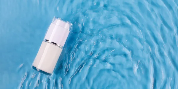 Mockup of a jar of moisturizing cream in water with ripples and a blue background. Cosmetic product for everyday makeup. Luxury cosmetics presentation