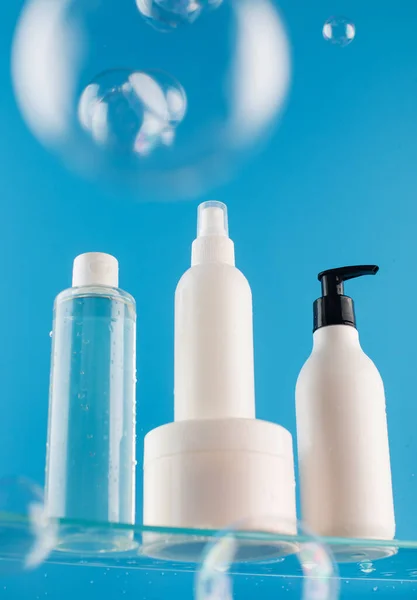 Set Different Mockups Cosmetic Product Glass Shelf Blue Background Jet — Stock Photo, Image